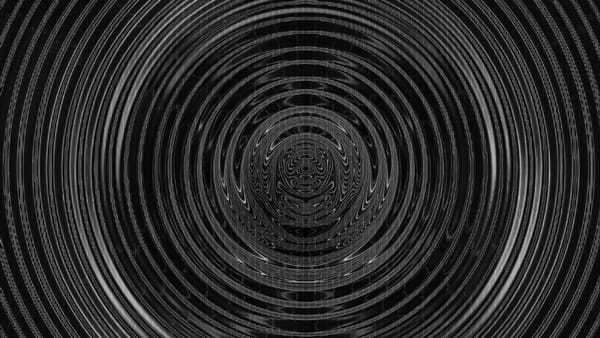 An image of black and grey concentric circles that appear to be moving in a vibration
